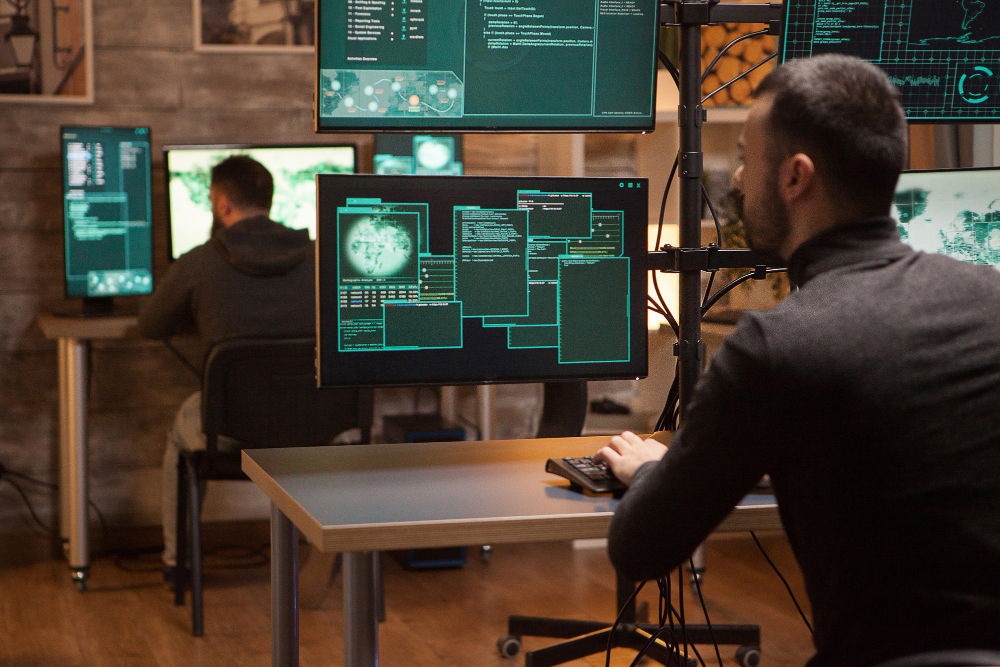 back-view-dangerous-team-hackers-working-new-malware (1)